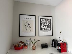 three framed pictures on a wall above a counter at Panoramic suite in Kastoria