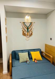 a blue couch with two stuffed animals sitting on it at Sweet Home in Gò Ba Quần