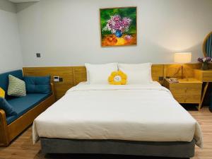 a bedroom with a bed with a teddy bear on it at Sweet Home in Gò Ba Quần