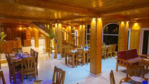a dining room with wooden tables and chairs at Mashobra Heights By shrpl in Kīar