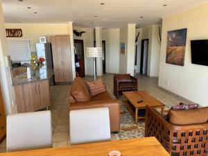 a living room with a couch and a table at 25 Sunset View in Langstrand