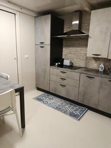 a kitchen with stainless steel cabinets and a table at Casa vacanze So Suite 24 in Reggio di Calabria