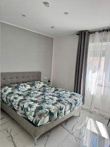 a bedroom with a bed in a room with a window at Mister House in Fiumicino