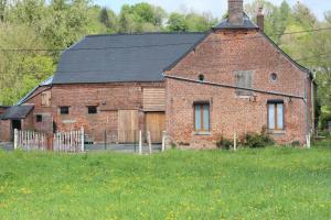 an old red brick building with a black roof at Country house in Erloy, Oise valley in Erloy