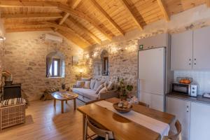 a kitchen and a living room with a table at Anemolithos Mani's House in Areopoli