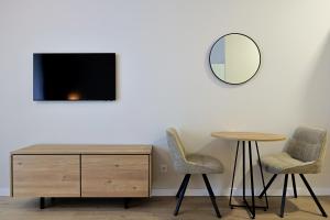 a room with two chairs and a table and a mirror at Mira Seaview Studio Apartment in Batumi in Batumi