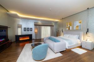 a large bedroom with a bed and a fireplace at Virunga Inn Resort & Spa in Kinigi
