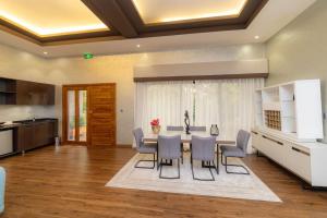 a kitchen and dining room with a table and chairs at Virunga Inn Resort & Spa in Kinigi +77 photos