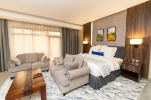 a large hotel room with a bed and a couch at Virunga Inn Resort & Spa in Kinigi