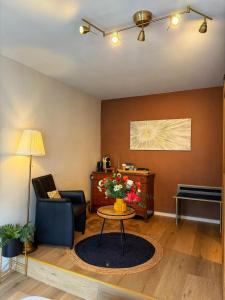 a living room with a table and a chair at Clemanbruges in Bruges