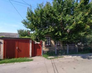 a house with a red door and a tree at Halvy 60 Apartments in Cherkasy
