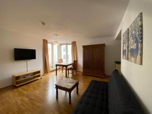 ein Wohnzimmer mit Sofa und Fernseher in der Unterkunft Avalon Bed & Breakfast Themen/- Nichtraucherhotel in Hannover