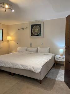 a bedroom with a large white bed in a room at Wave Rider Villa in Kouvéla