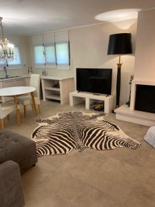 a zebra rug on the floor of a living room at Wave Rider Villa in Kouvéla +6 photos