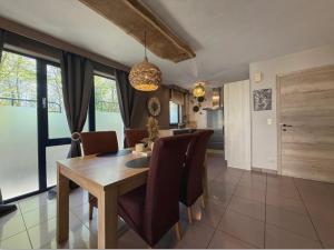 a dining room with a wooden table and chairs at Noax gite Durbuy in Durbuy
