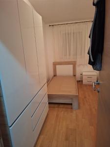 a small bedroom with a bed and a closet at King Apartment in Sutomore