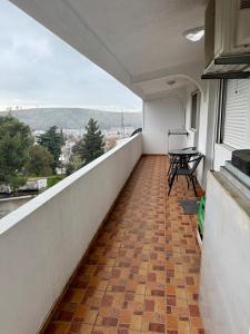 a balcony with a table and a view of a city at King Apartment in Sutomore
