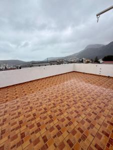 a room with a tile floor on a roof at King Apartment in Sutomore +4 photos