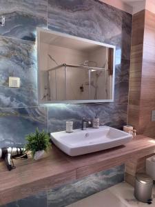 a bathroom with a sink and a mirror at Panoramic suite in Kastoria +38 photos