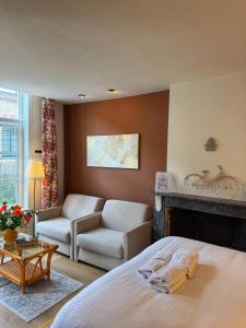 a bedroom with a bed and a living room at Clemanbruges in Bruges
