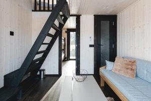 a living room with a blue couch and a staircase at WAKE INN by Pidu-LA in Abula