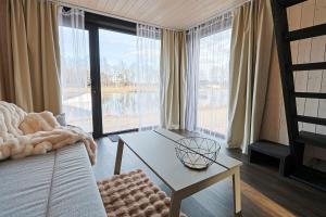 a living room with a couch and a table at WAKE INN by Pidu-LA in Abula