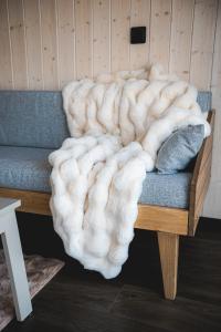 a blanket sitting on top of a couch at WAKE INN by Pidu-LA in Abula