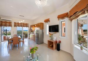 a kitchen and dining room with a table and chairs at Socrates Holidays Apt 3 with Pool near the Beach in Kamisianá