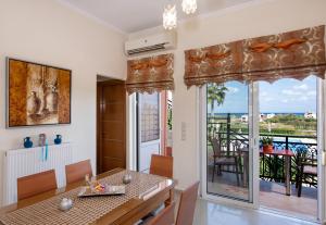 a dining room with a view of the ocean at Socrates Holidays Apt 3 with Pool near the Beach in Kamisianá