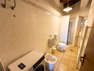 a bathroom with a toilet and a sink in it at Casa Ana Istria 1 in Savudrija