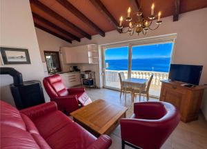 a living room with red furniture and a view of the ocean at Casa Ana Istria 1 in Savudrija
