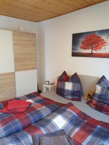 a bedroom with a bed and a tree on the wall at Ferienwohnung am Schwielochsee in Schwielochsee