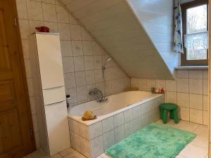 a bathroom with a bath tub in a room at Ferienhaus Brühler in Weiden +17 photos