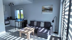 a living room with a couch and a table at Bele Lofts in Karmėlava