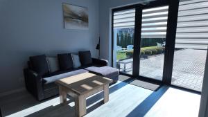 a living room with a couch and a coffee table at Bele Lofts in Karmėlava