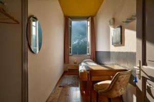 a room with a table and a chair and a window at Villa Edera Exclusive Rental in Auressio