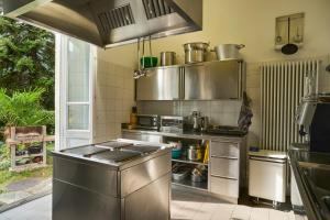 a kitchen with a large stainless steel stove top oven at Villa Edera Exclusive Rental in Auressio