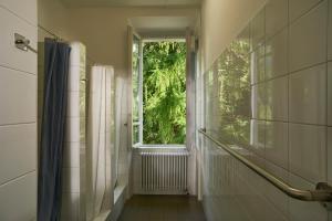 a bathroom with a window and a walk in shower at Villa Edera Exclusive Rental in Auressio