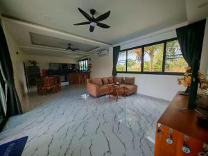 a living room with a couch and a ceiling fan at Beautiful accommodation on Lipa Noi in Nathon Bay