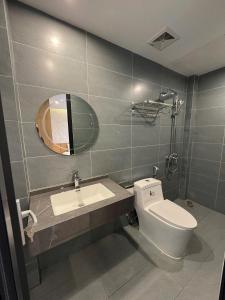 a bathroom with a toilet and a sink and a mirror at The C'mon Mộc Châu in Làng Môn +36 photos