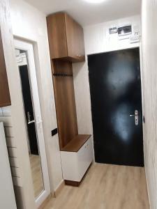 a room with a black garage door and a mirror at ევრო პალას გონიო in Kvariati +3 photos
