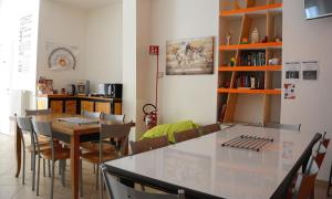 a dining room with a table and chairs at The Rock Hostel in Matera