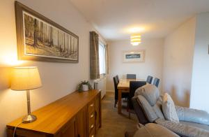 a living room with a couch and a table with chairs at Havrock in Orkney