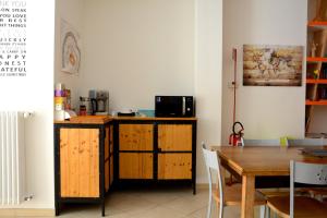a kitchen with a wooden table and a table and a dining room at The Rock Hostel in Matera +17 photos