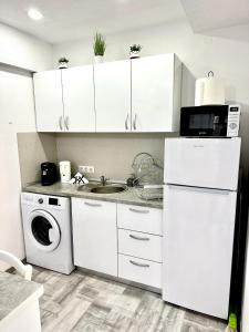 a kitchen with a white refrigerator and a sink at NextSpace Nr 2 in Sfântu-Gheorghe +8 photos