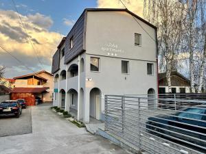 a white building with a sign on the side of it at NextSpace Nr 2 in Sfântu-Gheorghe