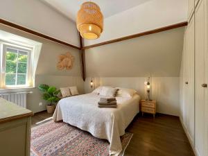 a bedroom with a bed and a ceiling at La Maison Maya Normandie in Saint-Éloi-de-Fourques +40 photos