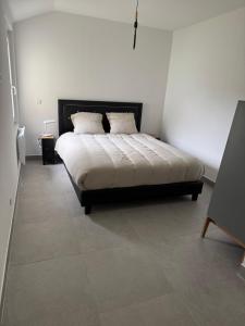 a bed in a bedroom with a tiled floor at sologne detente in Souesmes +8 photos