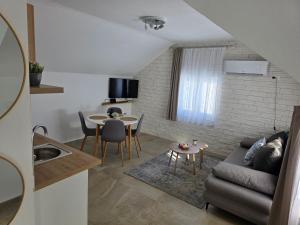 a living room with a couch and a table at Velebitska Vila in Gračac