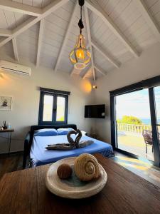 a bedroom with a bed and a large window at The Dona House in Vaia